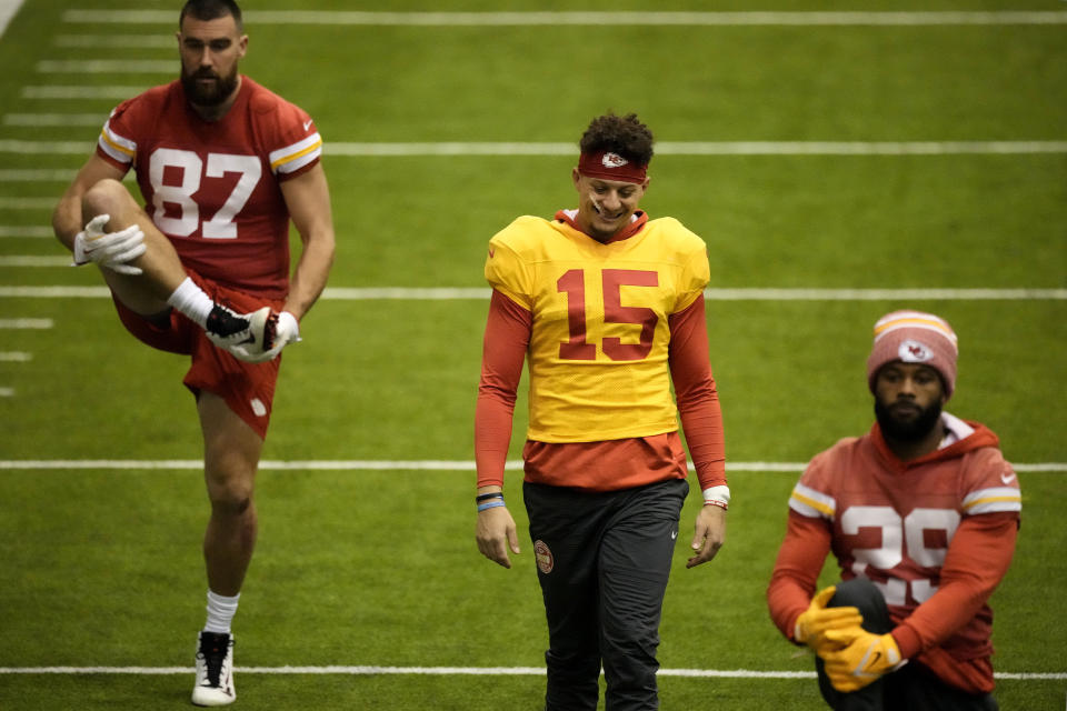 Kansas City Chiefs tight end Travis Kelce (87), quarterback Patrick Mahomes (15) and running back La'Mical Perine (29) stretch during the NFL football team's practice Wednesday, Jan. 24, 2024, in Kansas City, Mo. (AP Photo/Charlie Riedel)