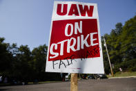 A sign is posted during a demonstration outside a General Motors facility in Langhorne, Pa., Monday, Sept. 23, 2019. The strike against General Motors by 49,000 United Auto Workers entered its second week Monday with progress reported in negotiations but no clear end in sight. (AP Photo/Matt Rourke)