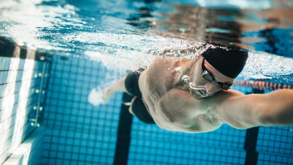 a photo of a man swimming front crawl