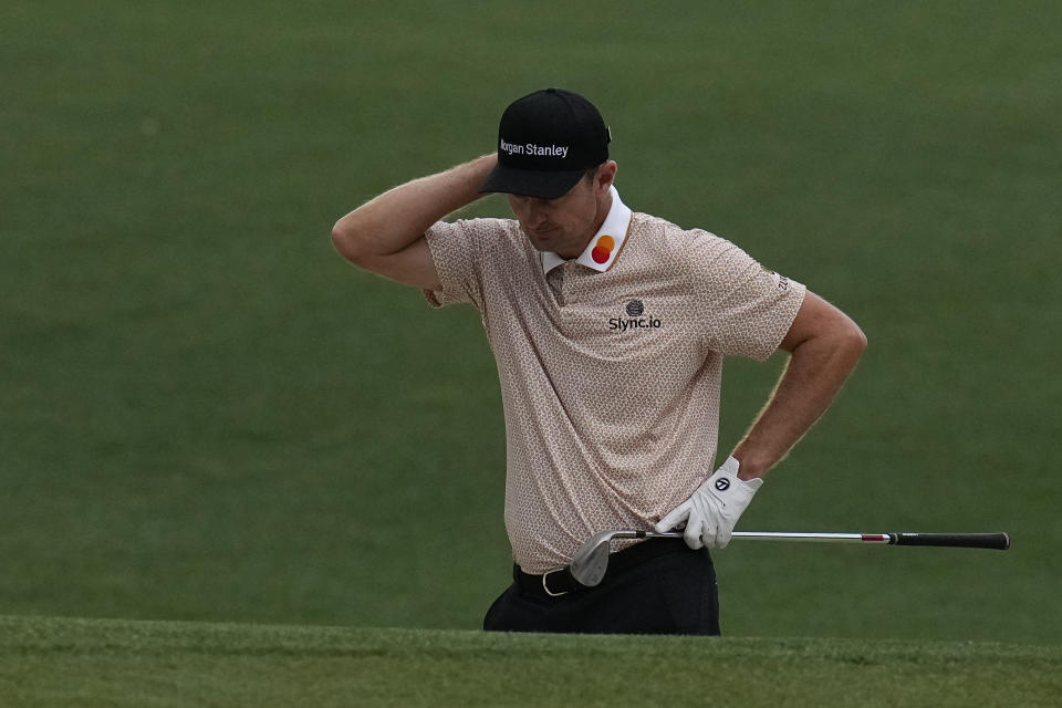 Justin Rose, of England, reacts after his chip shot out of a bunker on the 16th hole during the third round of the Masters golf tournament on Saturday, April 10, 2021, in Augusta, Ga. (AP Photo/Gregory Bull)