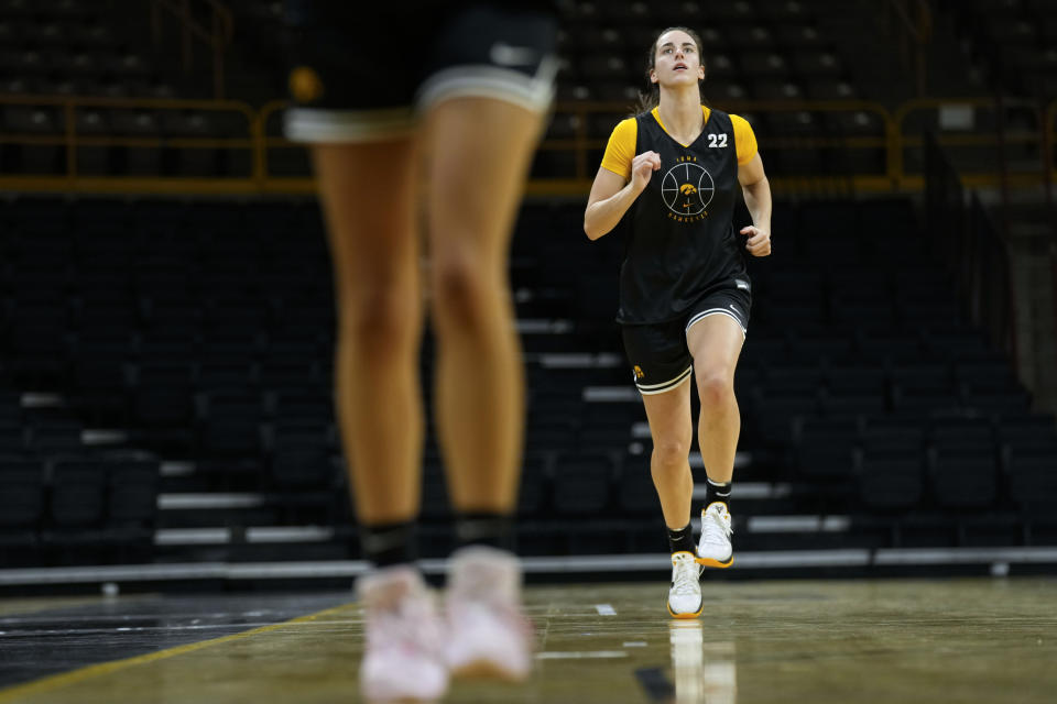 Iowa guard Caitlin Clark runs onto the court during practice after Iowa's NCAA college basketball media day Oct. 4, 2023, in Iowa City, Iowa. Clark is embracing her role as an ambassador for the game after she led Iowa to the NCAA championship game last season. She enters this season with 90 straight double-figure scoring games and a 27.3-point career average. (AP Photo/Charlie Neibergall)