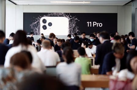 Customers view products at the Apple Store in IFC, Central district, Hong Kong, China