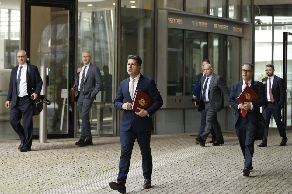 Gibraltar Chief Minister Fabian Picardo, center, walks with his delegation outside EU headquarters in Brussels, Friday, April 12, 2024. British and Spanish foreign ministers are scheduled to meet Friday with a top European Commission official for another round of negotiations over the status of the disputed territory of Gibraltar following Britain's exit from the European Union. (AP Photo/Omar Havana)