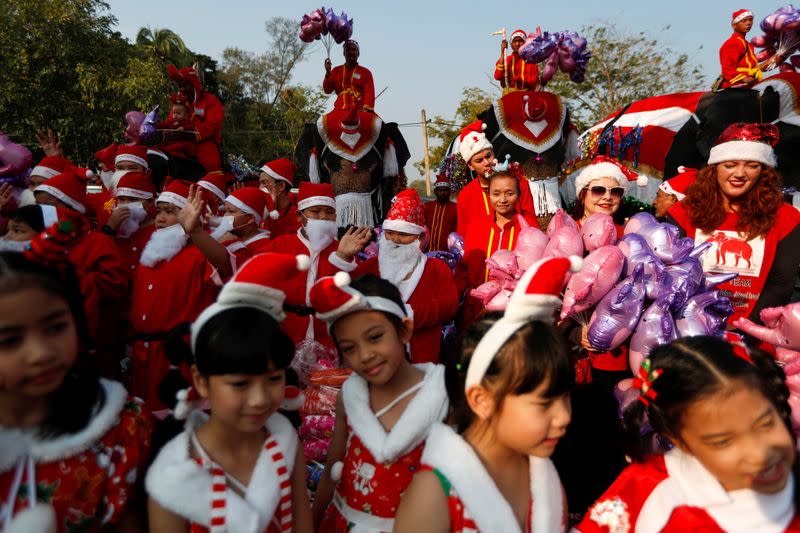 Elephants distribute Christmas presents to students at a school in Ayutthaya