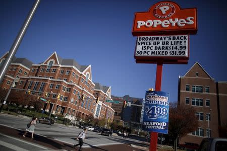 A popeyes restaurant sign is seen on the intersections of Broadway and New Orleans a cross the street from the John Hopkins Hospital in Baltimore, Maryland November 4, 2015. REUTERS/Carlos Barria