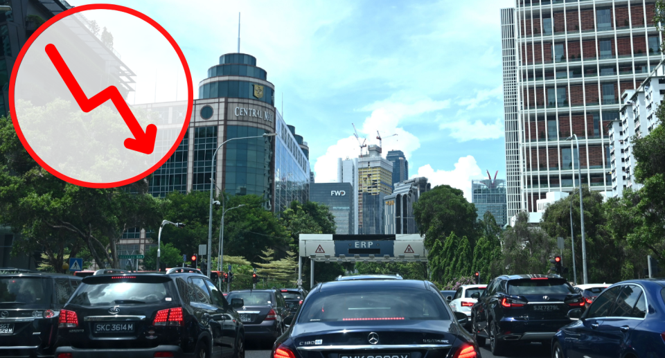 Vehicles stopping at a traffic light in downtown Singapore, illustrating a story on COE prices.