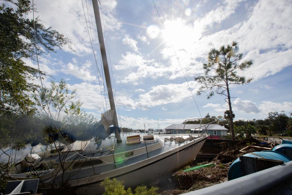 A sailboat washed ashore by Hurricane Idalia sits on the side of the rode in Steinhatchee, Fla. on Wednesday, Aug. 30, 2023.