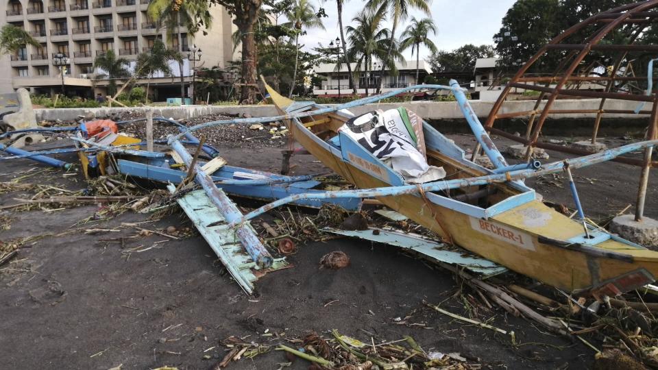 An outrigger boat destroyed by Tphioon Phanfone sits on the coastline Thursday Dec. 26, 2019, in Ormoc City, central Philippines. The typhoon left over a dozen dead and many homeless. (AP Photo)