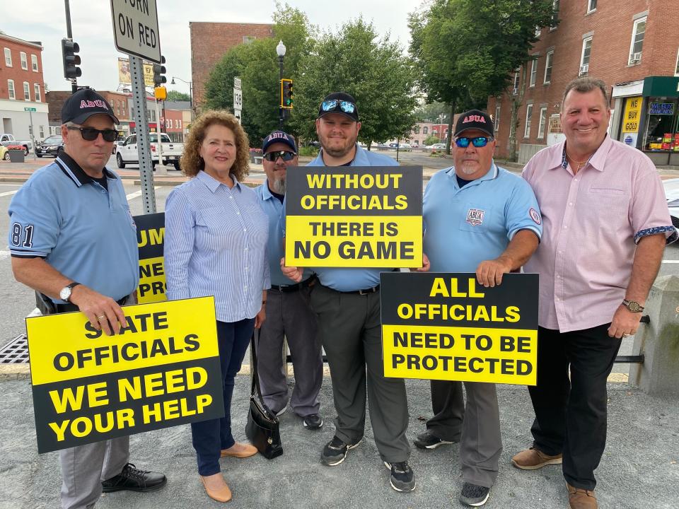 From left, umpire Karl Stennstrom; State Rep. Carol Doherty, D-Taunton; umpire Tim White; umpire Dave Pedro; Greater Taunton Amateur Baseball Umpires Association President Dominic Damiano; and Taunton City Councilor John McCaul at a demonstration by the umpires on the Taunton Green on Wednesday, July 12, 2023, in support of legislation to protect youth sports officials.