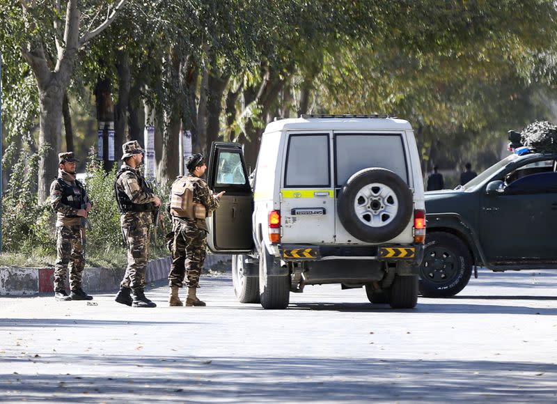 Afghan security forces stand guard during an attack near the university of Kabul