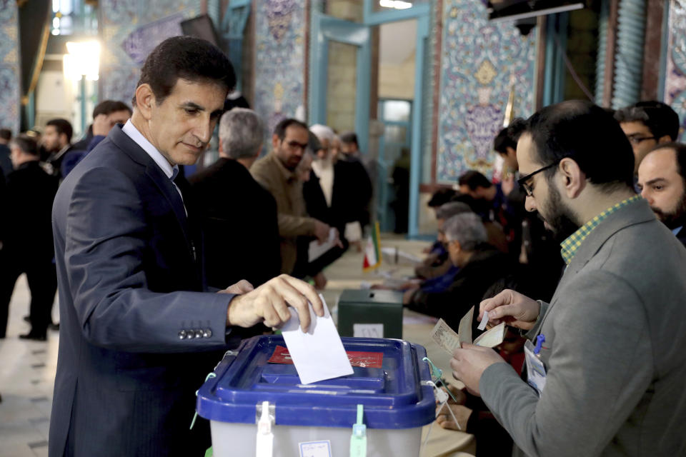 A man casts his vote during the parliament elections at a polling station in Tehran, Iran, Friday, Feb. 21, 2020. Iranians began voting for a new parliament Friday, with turnout seen as a key measure of support for Iran's leadership as sanctions weigh on the economy and isolate the country diplomatically. (AP Photo/Ebrahim Noroozi)