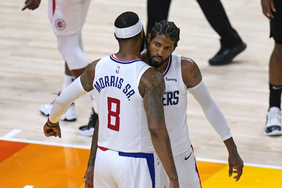 Los Angeles Clippers' Marcus Morris Sr. (8) and Paul George, rear, celebrate during the second half of Game 5 of the team's second-round NBA basketball playoff series against the Utah Jazz on Wednesday, June 16, 2021, in Salt Lake City. (AP Photo/Rick Bowmer)