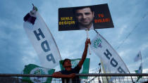 A supporter of Turkey's main pro-Kurdish Peoples' Democratic Party (HDP) holds a portrait of their jailed former leader and presidential candidate Selahattin Demirtas during a campaign event in Istanbul, Turkey, June 17, 2018. REUTERS/Huseyin Aldemir