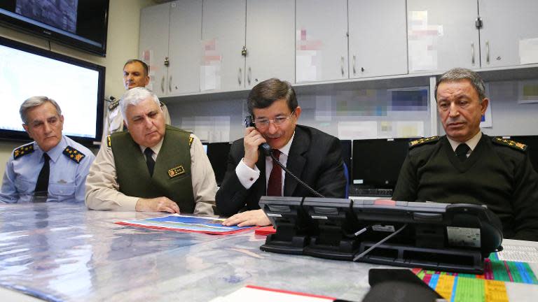 Handout picture by Turkish Prime Minister's Press Office on February 22, 2015, shows Prime Minister Ahmet Davutoglu (C) following the operation of the relocation of Saygi Outpost and Tomb of Suleyman Shah, in Ankara