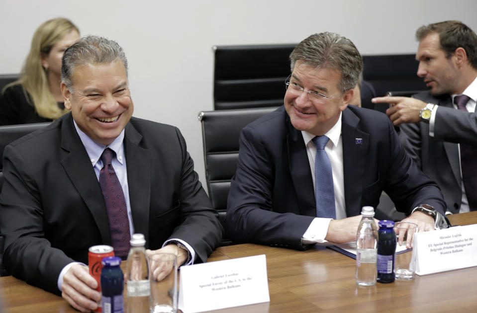 U.S. Deputy Assistant Secretary Gabriel Escobar, left, and European Union envoy Miroslav Lajcak react, during talks on normalizing relations between Serbia and Kosovo, in northern, Serb-dominated part of ethnically divided town of Mitrovica, Kosovo, Thursday, Aug. 25, 2022. U.S. and European Union envoys met with Kosovo Serbs in a last-ditch effort to avert further tensions between Serbia and Kosovo after a meeting last week in Brussels ended with no agreement on a dispute between the former Balkan war foes. (AP Photo/Bojan Slavkovic)