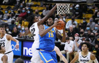 Colorado forward Jabari Walker, left, fouls UCLA center Myles Johnson during the first half of an NCAA college basketball game Saturday, Jan. 22, 2022, in Boulder, Colo. (AP Photo/David Zalubowski)