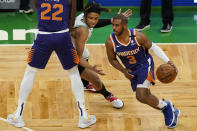 Phoenix Suns guard Chris Paul (3) dribbles upcourt as teammate Deandre Ayton (22) sets a pick against Boston Celtics guard Romeo Langford in the first half of an NBA basketball game, Thursday, April 22, 2021, in Boston. (AP Photo/Elise Amendola)