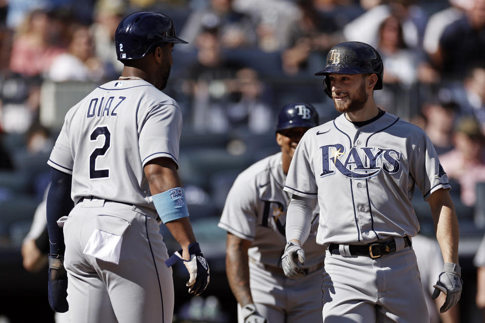 Tampa Bay Rays' Brandon Lowe celebrates a three-run home run with Yandy Diaz (2) during the third inning of a baseball game against the New York Yankees on Saturday, Oct. 2, 2021, in New York. (AP Photo/Adam Hunger)