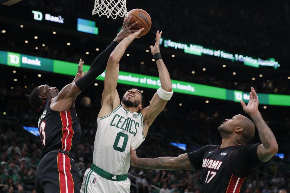Miami Heat's Bam Adebayo, left, blocks a shot by Boston Celtics' Jayson Tatum (0) during the second half of Game 3 of the NBA basketball playoffs Eastern Conference finals Saturday, May 21, 2022, in Boston. (AP Photo/Michael Dwyer)