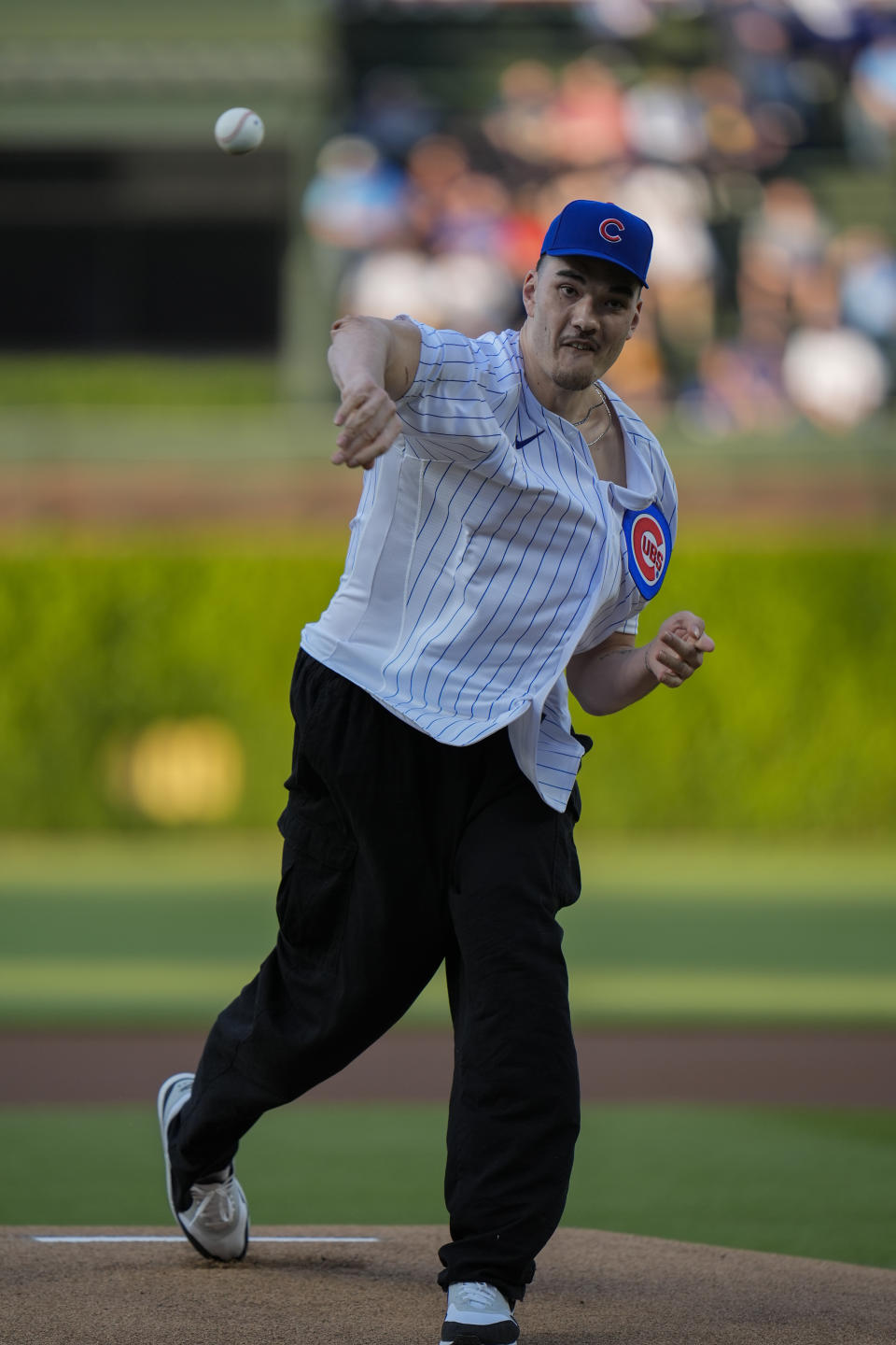 Purdue basketball player Zach Edey throws out a ceremonial first pitch before a baseball game between the San Diego Padres and the Chicago Cubs, Monday, May 6, 2024, in Chicago. (AP Photo/Erin Hooley)