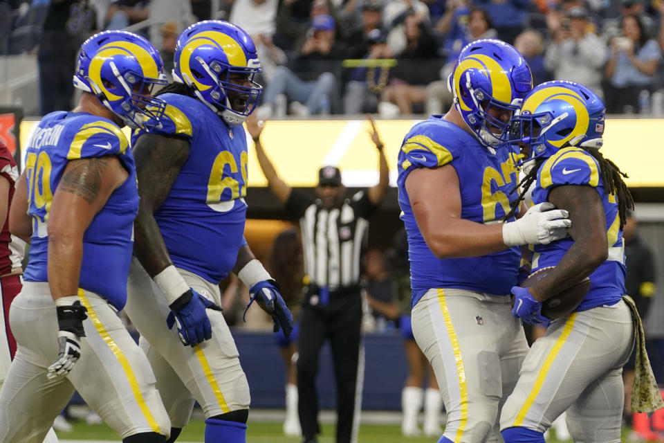 Los Angeles Rams running back Darrell Henderson Jr., right, celebrates his rushing touchdown with teammates during the second half of an NFL football game against the Arizona Cardinals Sunday, Nov. 13, 2022, in Inglewood, Calif. (AP Photo/Mark J. Terrill)