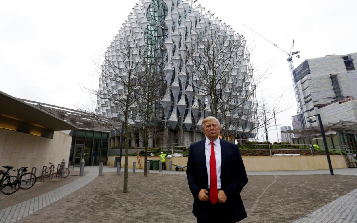 A Madame Tussauds wax figure of US President Donald Trump is seen outside the new US Embassy in Nine Elms in London - AP