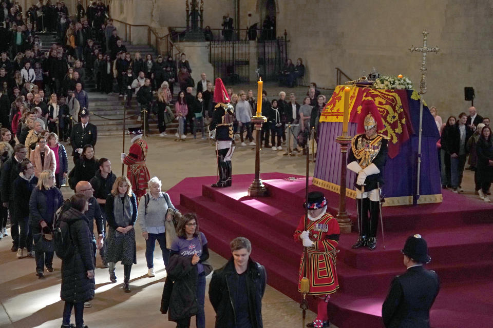 Members of the public view the coffin of Queen Elizabeth II, lying in state on the catafalque in Westminster Hall, at the Palace of Westminster, London, ahead of her funeral on Monday. Picture date: Sunday September 18, 2022.