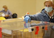 A woman casts her vote during presidential runoff election in Krakow, Poland, Sunday, July 12, 2020. Voting started Sunday in Poland’s razor-blade-close presidential election runoff between the conservative incumbent Andrzej Duda and liberal, pro-European Union Warsaw Mayor Rafal Trzaskowski.(AP Photo/Petr David Josek)