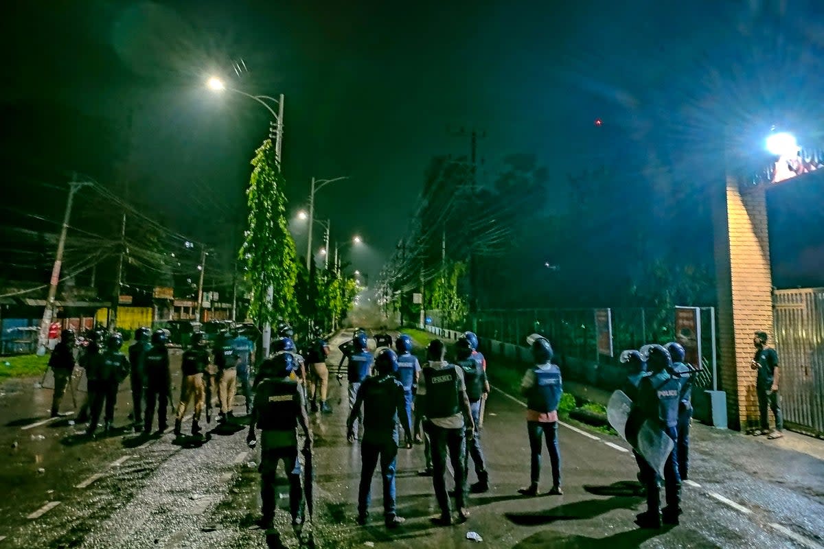 Police personnel disperse an angry crowd during a clash after burning of Qurans in Sylhe (AFP via Getty Images)