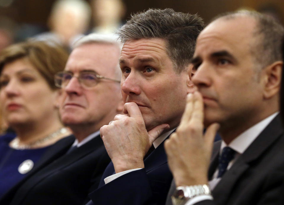 FILE - Keir Starmer, second right, of the Labour party listens to Leader of the opposition Labour Party Jeremy Corbyn's speech laying out the plan for the party following the Brexit vote in June 2016, in London, Friday, Feb. 24, 2017. (AP Photo/Alastair Grant, File)