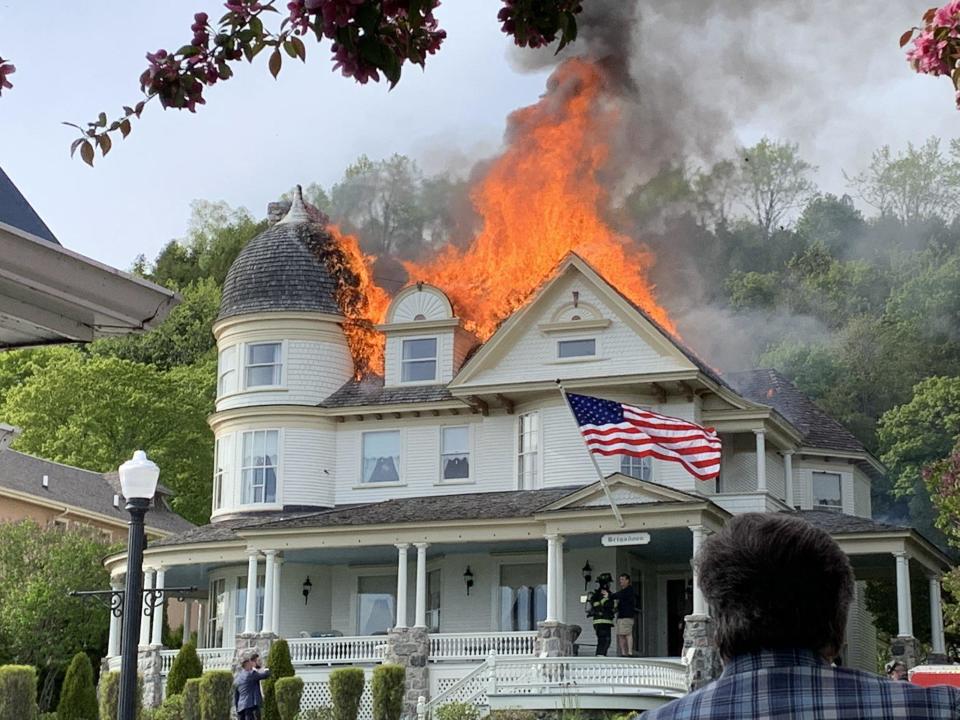 A cottage next to a couple's wedding venue went up in flames, forcing them to move venues during the event.  / Credit: Angela Hopkins