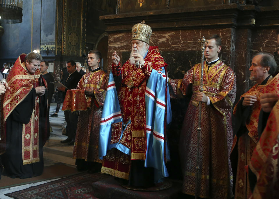 FILE - In this Thursday Oct. 11, 2018 file photo, Patriarch Filaret, head of the Ukrainian Orthodox Church of the Kiev Patriarchate, conducts a service at the Volodymysky Cathedral in Kiev, Ukraine. Tensions over the imminent formation of a Ukrainian Orthodox church independent of Moscow are raising fears that nationalists may try to seize Russian church properties. (AP Photo/Efrem Lukatsky, FILE)