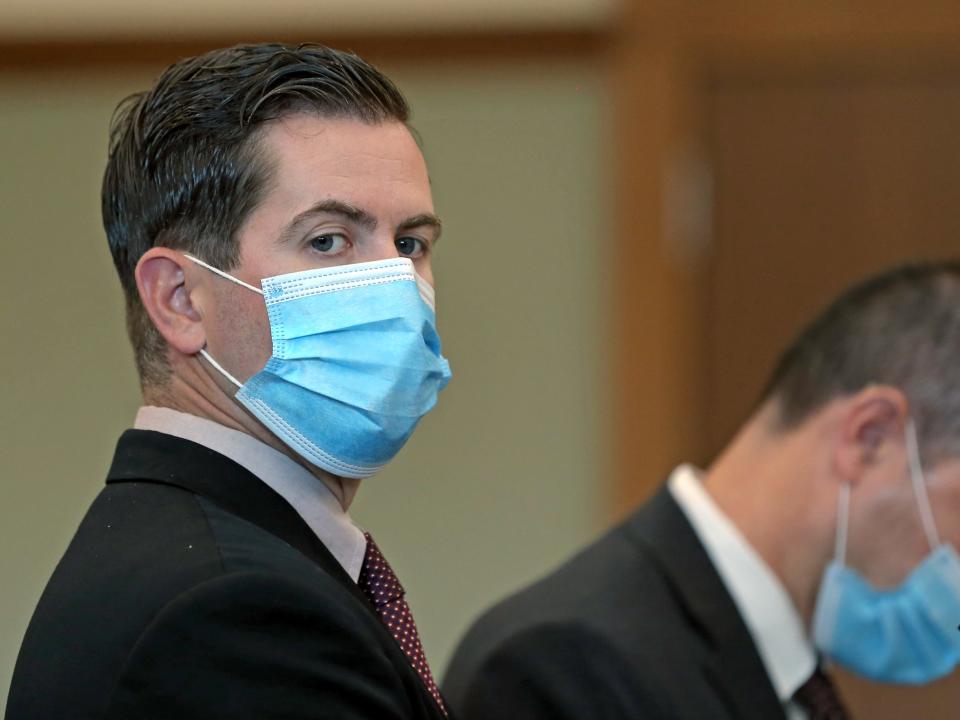 Pawtucket Patrolman Daniel Dolan Jr. (left) with his attorney Michael J. Collucci at his arraignment at Kent County Superior Court in Warwick, R.I., on July 16, 2021.