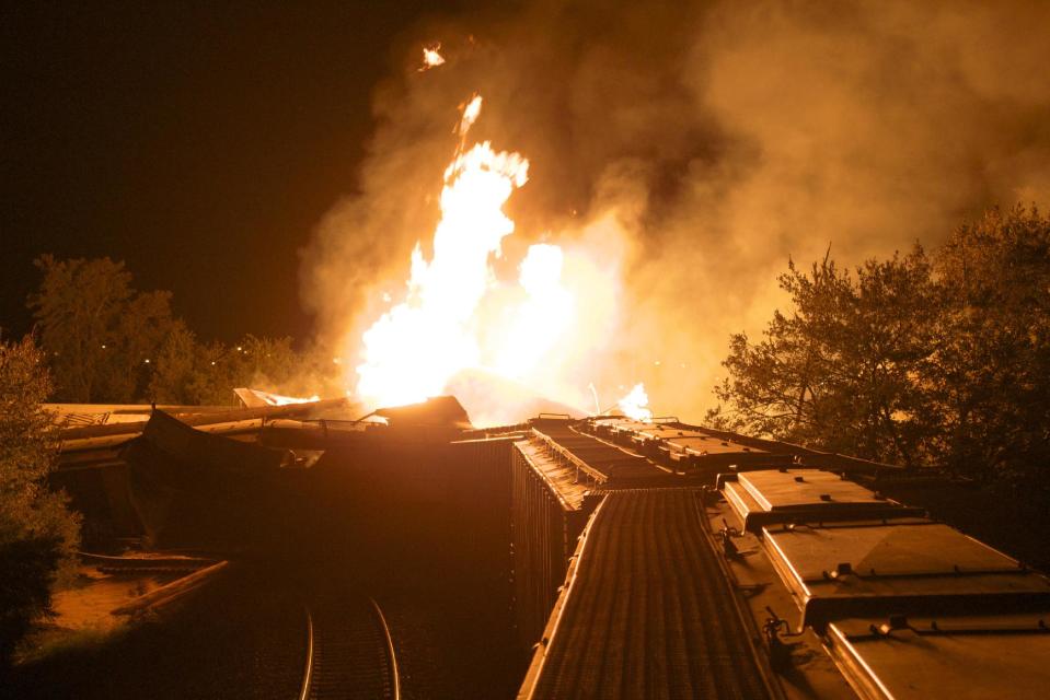 Flames rise from a derailed freight train early Wednesday July 11, 2012 in Columbus, Ohio. Part of a freight train derailed and caught fire in Ohio's capital city early Wednesday, shooting flames skyward into the darkness and prompting the evacuation of a mile-wide area as firefighters and hazardous materials crews worked to determine what was burning and contain the blaze.(AP Photo/Chris Mumma)