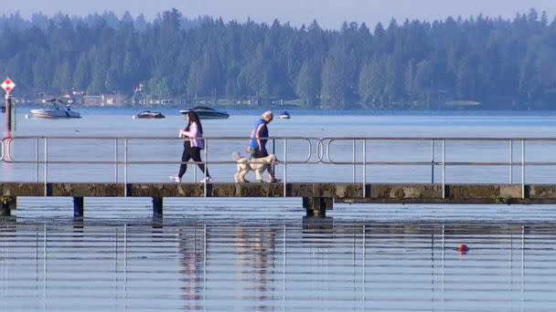 PHOTO: People walk along the water before the temperatures rise, July 26, 2022, in Seattle. (KOMO)
