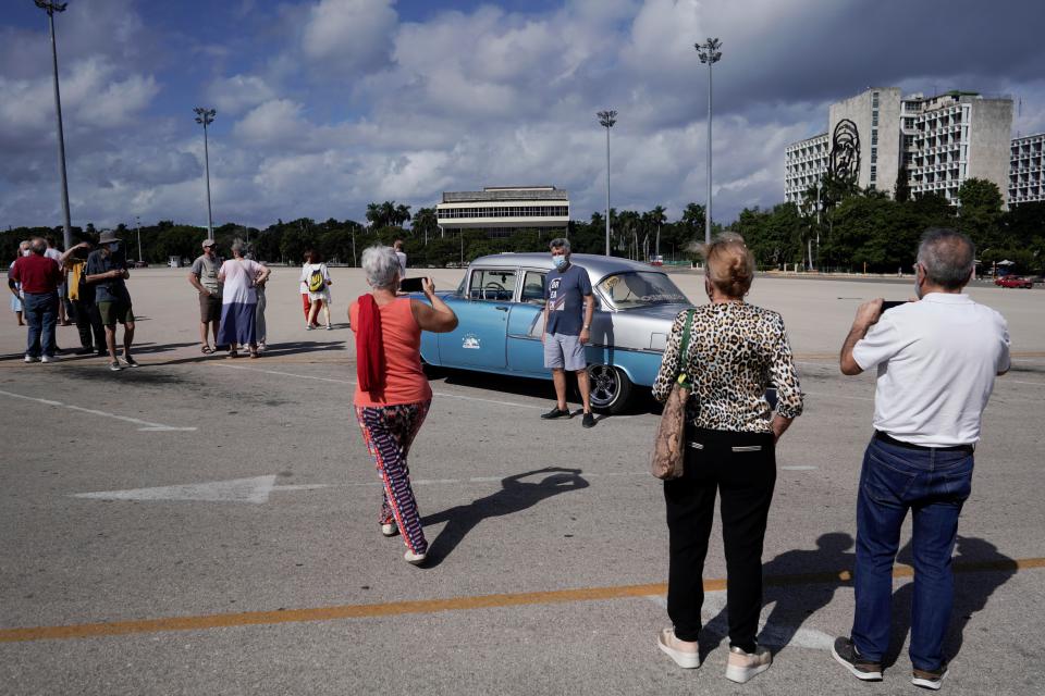 Tourists from Spain take pictures at the Revolution square in Havana, Cuba, on Tuesday (REUTERS)