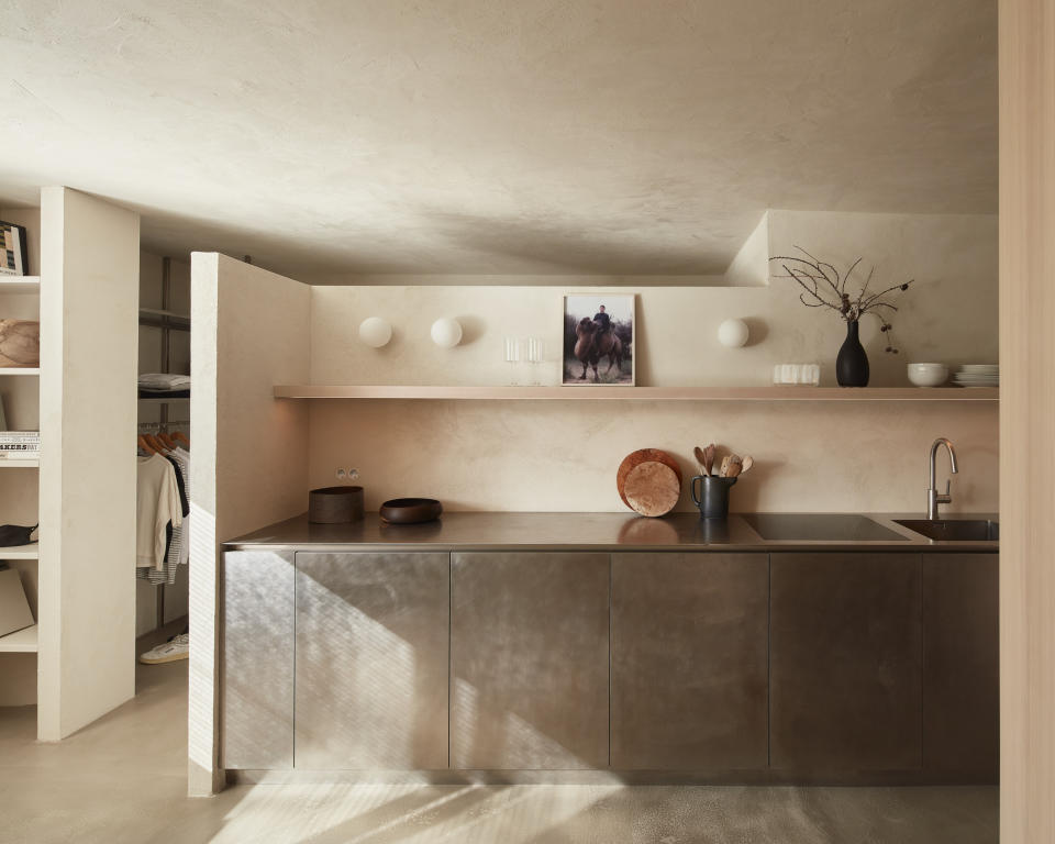 minimalist kitchen with plaster walls and stainless steel cabinets