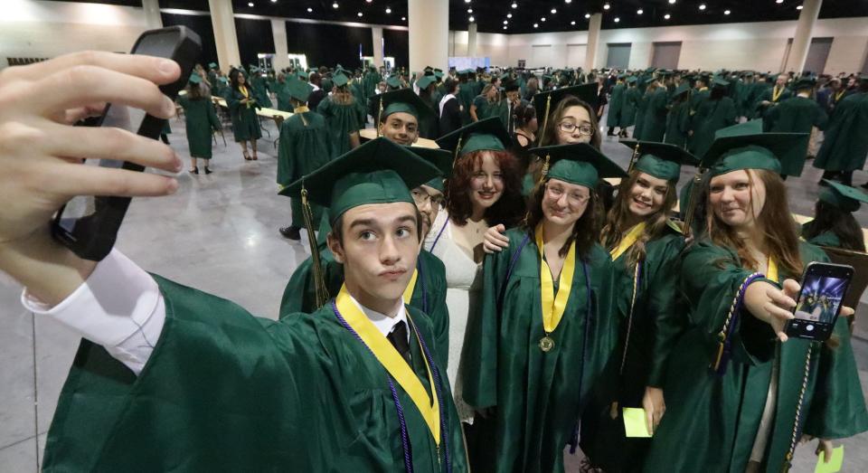 Time for a selfie as seniors get ready to receive their diplomas during DeLand High School graduation ceremonies at the Ocean Center in Daytona Beach on Tuesday.