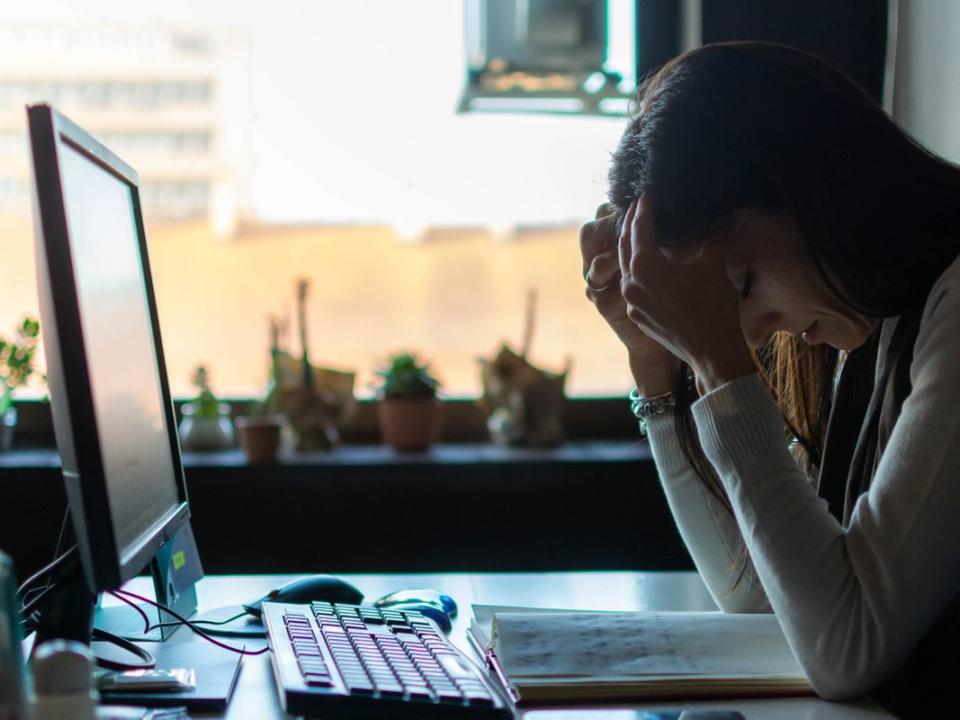 Businesswoman frustrated by bad new at office desk