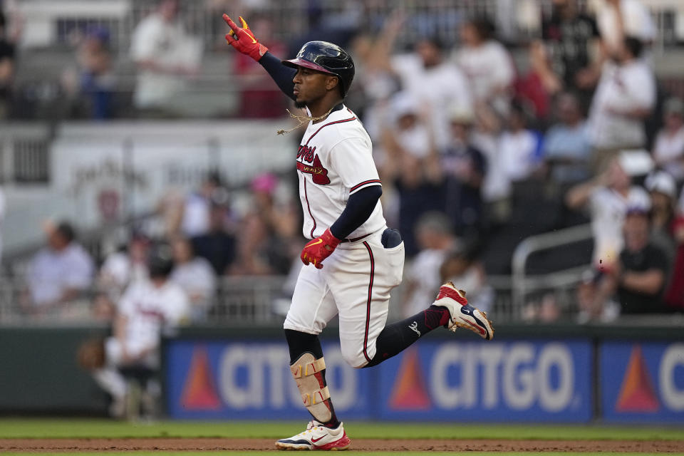 Atlanta Braves' Ozzie Albies gestures as he rounds the bases after hitting a solo home run in the first inning of a baseball game against the St. Louis Cardinals, Tuesday, Sept. 5, 2023, in Atlanta. (AP Photo/John Bazemore)