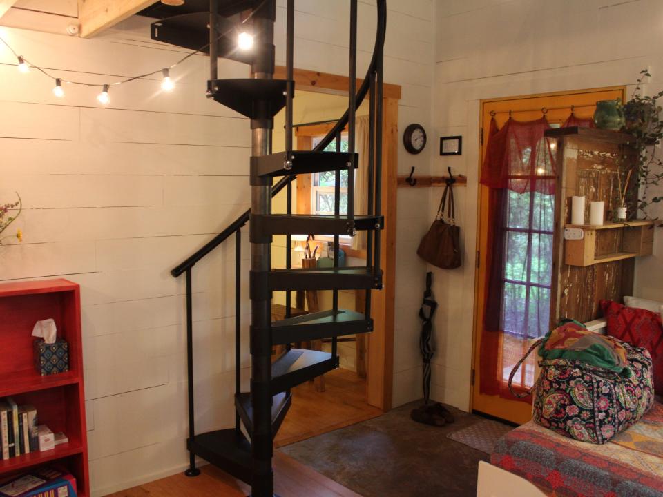a spiral staircase inside the tiny house