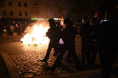 German riot police walk past bonfire set by protesters on the street during the demonstration during the G20 summit in Hamburg, Germany, July 6, 2017. REUTERS/Fabian Bimmer