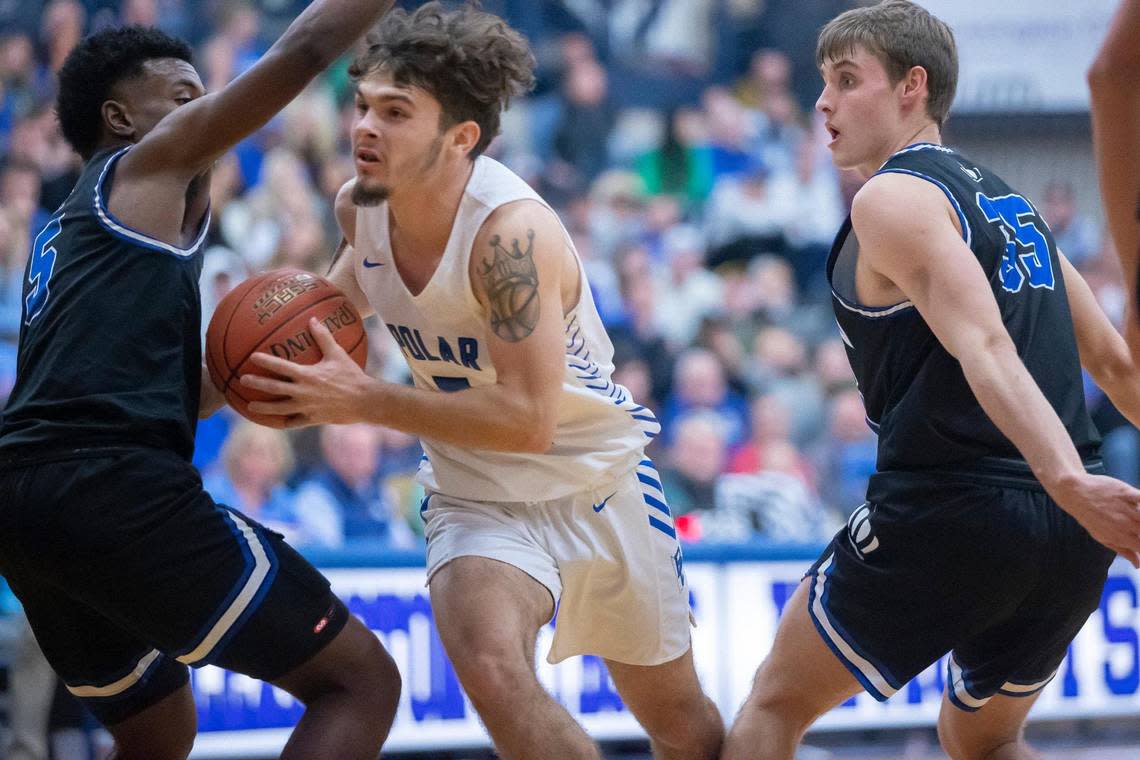 Bracken County’s Blake Reed (5) tries to drive around Mason County’s Khristian Walton (5) during the opening round of the White, Greer & Maggard Holiday Classic at Lexington Catholic High School on Tuesday. Reed scored 47 points for Bracken County in the loss.