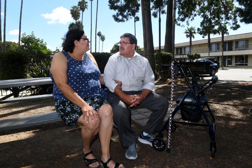 Charles and Myrna Szabo sit in a garden at the former Vagabond Inn in Oxnard on Sept. 19. The former motel provides temporary shelter for individuals facing homelessness through the state's Project Roomkey. The project was initiated to reduce the spread of COVID-19 among the homeless.