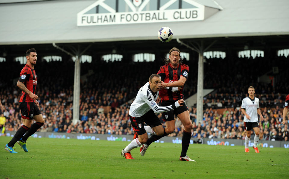 Fulham's Dimitar Berbatov (Right) is tackled by WBA'S Jonas Olsson during the Barclays Premier League match at Craven Cottage, London.