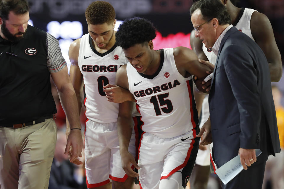Georgia's Sahvir Wheeler (15) is helped off the court after an injury during the team's NCAA college basketball game against Tennessee on Wednesday, Jan. 15, 2020, in Athens, Ga. (Joshua L. Jones/Athens Banner-Herald via AP)