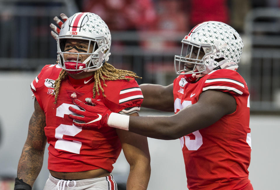 Ohio State defensive end Chase Young (2) is congratulated by Zach Harrison (33) after a sack against the Penn State Nittany Lions. (USA Today)