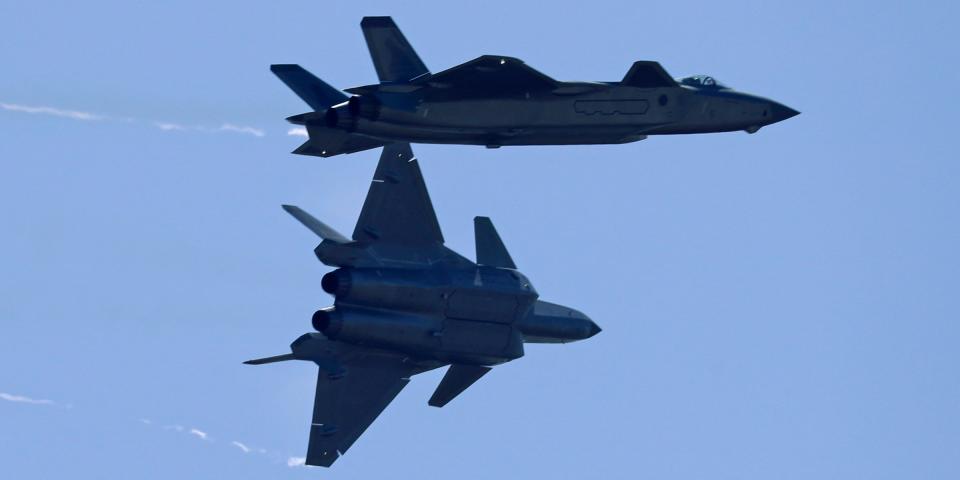 Two J-20 stealth fighter jets of the Chinese People's Liberation Army (PLA) Air Force perform during the 12th China International Aviation and Aerospace Exhibition, also known as Airshow China 2018, Tuesday, Nov. 6, 2018, in Zhuhai city, south China's Guangdong province.