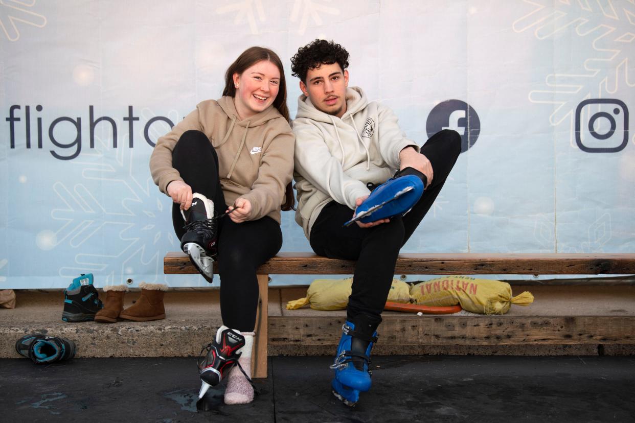 Cara Ellerkamp, left, and Sean Maddox take of their skates after getting of the rink at Flight on Ice Neshaminy Mall on Thursday, Dec. 29, 2022.