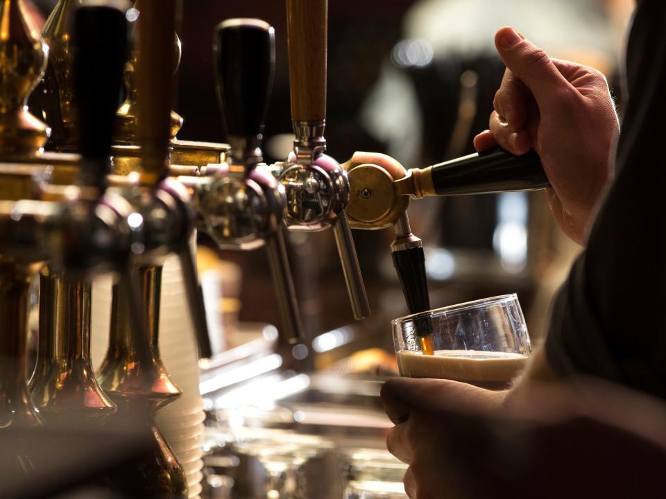 A barman pours a Guinness at an Irish bar.